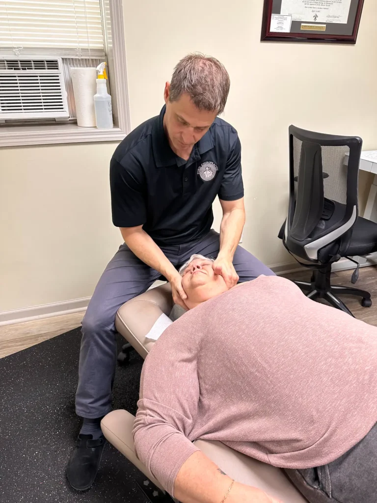 Dr. Gamache performing a cervical adjustment.