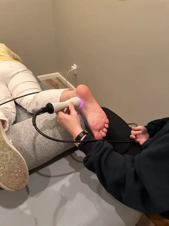Megan performing laser therapy for plantar fasciitis